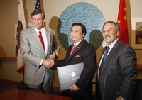 After signing a memorandum of understanding that will lead to a $10 million gift to UC Riverside, Chinese inventor and businessman Winston Chung and UC Riverside Chancellor Timothy P. White shake hands as Reza Abbaschian, dean of the Bourns College of Engineering, looks on. Photo credit: Peter Phun