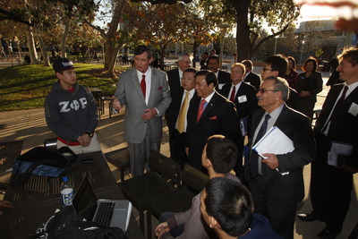 UC Riverside Chancellor Timothy B. White and Chinese inventor and businessman Winston Chung talk with students on campus.