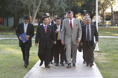 UC Riverside Chancellor Timothy B. White and Chinese inventor and businessman Winston Chung lead a group walking across campus.